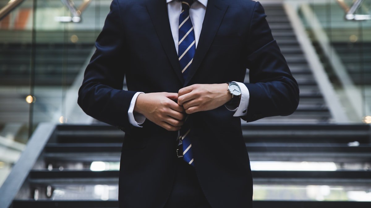 Executive standing in modern skyscraper looking at urban growth representing career paths
