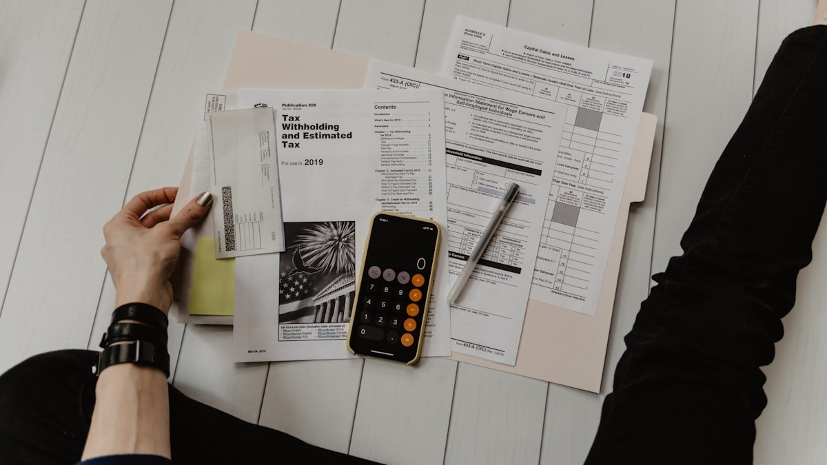 Young professional calculating monthly budget on spreadsheet using modern financial software