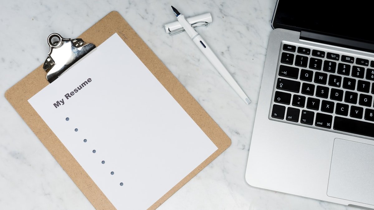 Recent college graduate reviewing optimized modern resume for corporate job application